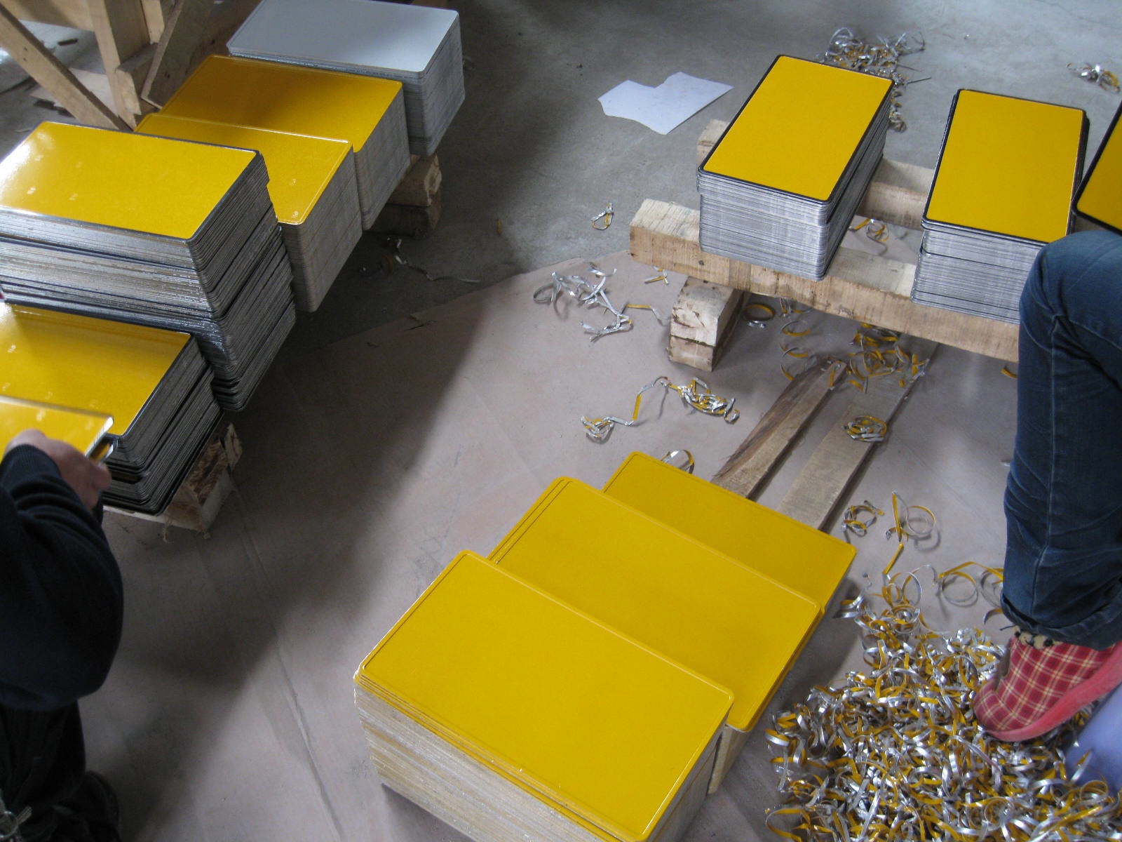 Stacks of yellow semi-finished plate blanks during production